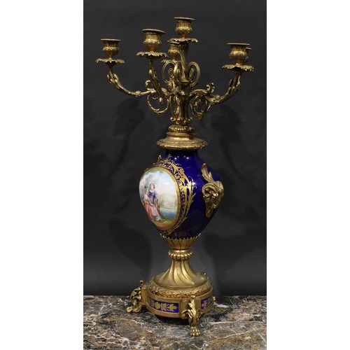 2083 - A pair of 19th century gilt metal and porcelain six light candelabra, acanthus scroll branches, camp... 