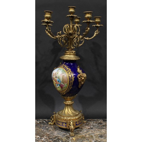 2083 - A pair of 19th century gilt metal and porcelain six light candelabra, acanthus scroll branches, camp... 