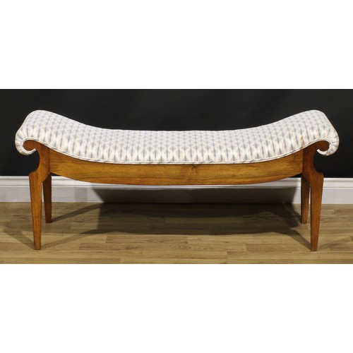 1560 - An Egyptian Revival inspired mahogany window seat, stuffed-over upholstery, tapered legs, 49cm high,... 