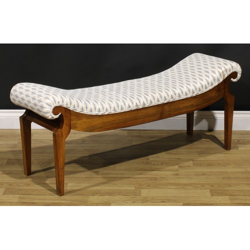 1560 - An Egyptian Revival inspired mahogany window seat, stuffed-over upholstery, tapered legs, 49cm high,... 