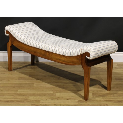 1560 - An Egyptian Revival inspired mahogany window seat, stuffed-over upholstery, tapered legs, 49cm high,... 