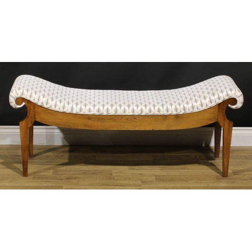 1560 - An Egyptian Revival inspired mahogany window seat, stuffed-over upholstery, tapered legs, 49cm high,... 