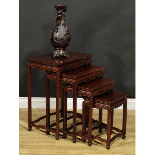 1294 - A Chinese hardwood quartetto nest of occasional tables, rectangular panel tops, humpback stretchers,... 