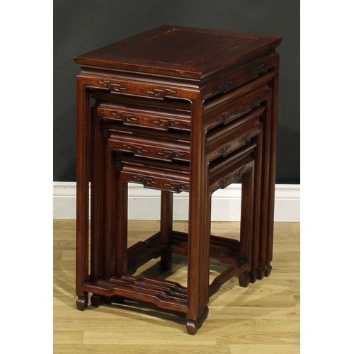 1294 - A Chinese hardwood quartetto nest of occasional tables, rectangular panel tops, humpback stretchers,... 