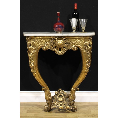 1561 - An Italian giltwood console table, possibly Tuscan, serpentine Carrara marble top, carved throughout... 