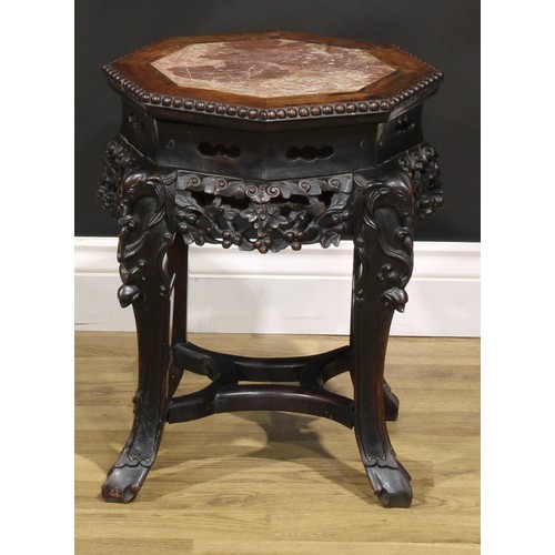 1435 - A Chinese hardwood jardiniere stand, octagonal top with beaded edge and inset marble panel, shaped a... 