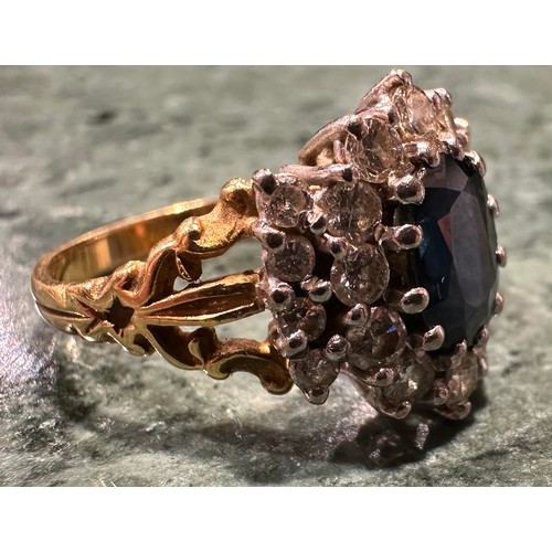 910 - A sapphire and diamond cluster ring, central oval pale blue sapphire measuring approx 8.51mm x 6.29m... 