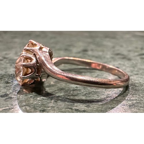 936 - An old brilliant cut diamond twist ring, twisting crest set with two round diamonds each measuring a... 