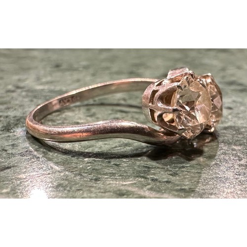 936 - An old brilliant cut diamond twist ring, twisting crest set with two round diamonds each measuring a... 