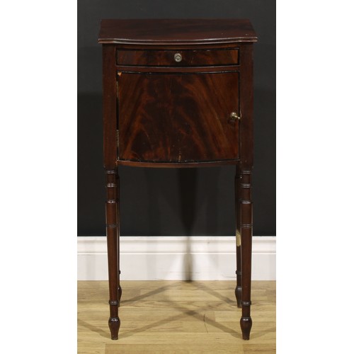 1242 - A 19th century mahogany bedroom cabinet, flame-veneered top above a drawer and door, turned legs, 75... 