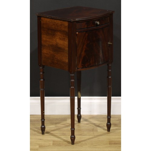 1242 - A 19th century mahogany bedroom cabinet, flame-veneered top above a drawer and door, turned legs, 75... 