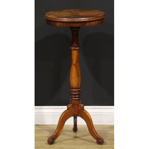 1531 - A 19th century walnut wine table or urn stand, circular top with radiating veneers, lotus apron, tur... 