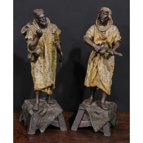 2176 - A pair of Orientalist type cold painted spelter figures, Arabian Bedouin entertainers, 45cm and 44cm... 