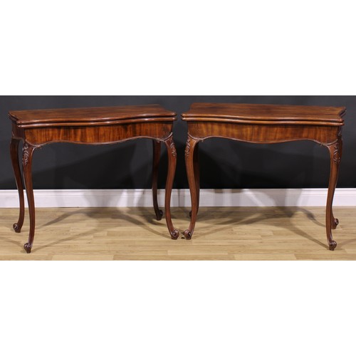 2170 - A pair of George III mahogany serpentine card tables, in the French Hepplewhite manner, each with a ... 