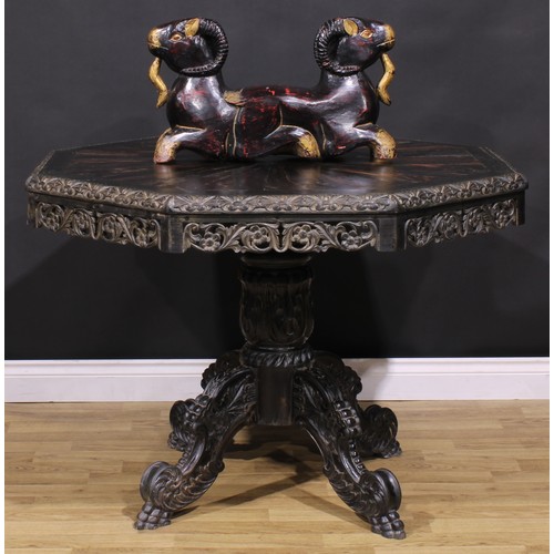 1285 - A 19th century Anglo-Indian ebony centre table, octagonal top with well-figured radiating veneers an... 