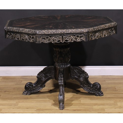 1285 - A 19th century Anglo-Indian ebony centre table, octagonal top with well-figured radiating veneers an... 