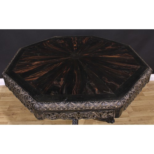 1285 - A 19th century Anglo-Indian ebony centre table, octagonal top with well-figured radiating veneers an... 