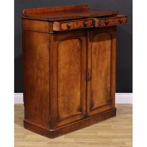 1477 - A Victorian mahogany housekeeper’s linen cupboard, slightly oversailing top with shallow half-galler... 