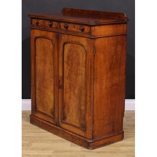 1477 - A Victorian mahogany housekeeper’s linen cupboard, slightly oversailing top with shallow half-galler... 