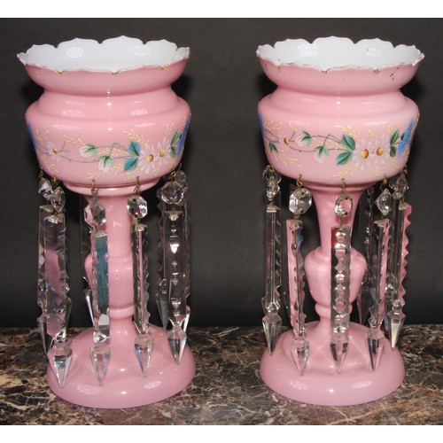 322 - A pair of Victorian pink and white opaque glass table lustres, painted with a band of stylised flowe... 