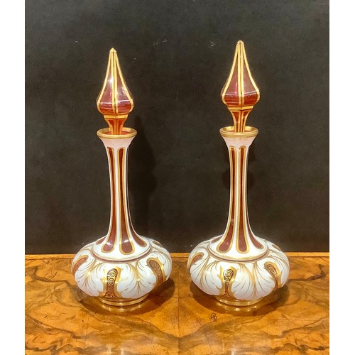 314 - A pair of 19th century Bohemian cased milk and cranberry glass scent bottles, elongated faceted neck... 