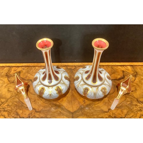 314 - A pair of 19th century Bohemian cased milk and cranberry glass scent bottles, elongated faceted neck... 