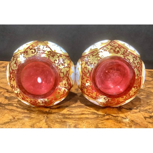 314 - A pair of 19th century Bohemian cased milk and cranberry glass scent bottles, elongated faceted neck... 