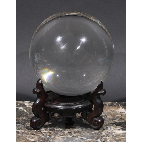 1865 - Mysticism and the Occult - a crystal ball, Chinese hardwood stand, 18cm high overall