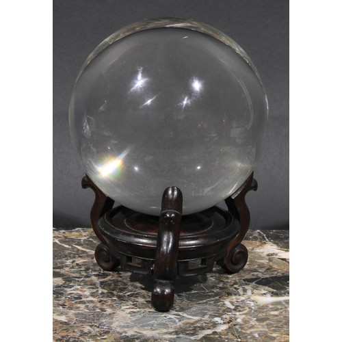 1865 - Mysticism and the Occult - a crystal ball, Chinese hardwood stand, 18cm high overall