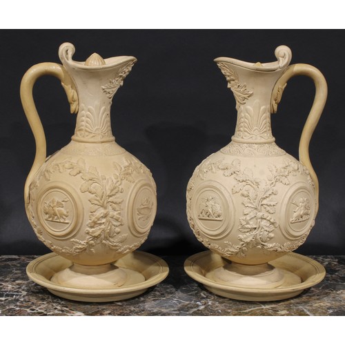 2082 - A pair of 19th century buff terracotta ewers, moulded and sprigged in the Renaissance taste with fru... 