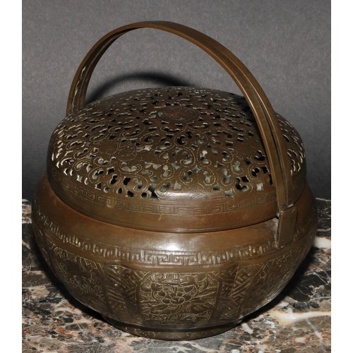 402 - A Chinese brass melon shaped hand warmer or brazier, pierced, chased and engraved, swing handles, 16... 