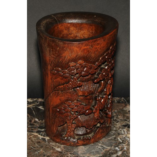 400 - A Chinese bamboo bitong brush pot, carved with figures amongst pines and prunus, 19cm high