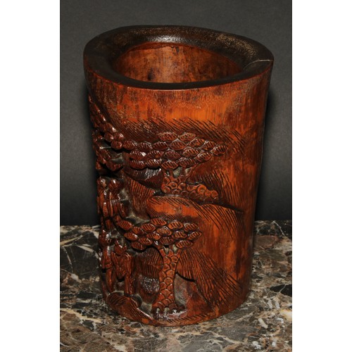 400 - A Chinese bamboo bitong brush pot, carved with figures amongst pines and prunus, 19cm high