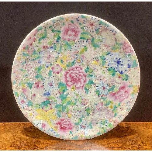 391 - A Chinese circular charger, painted in the famille rose palette with layered flowers, 33.5cm diam, r... 