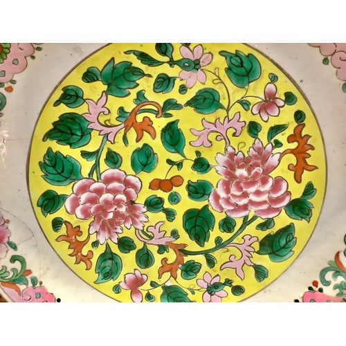 415 - A Chinese Penang Straits porcelain charger, enamelled in tones of pink, yellow and green with flower... 