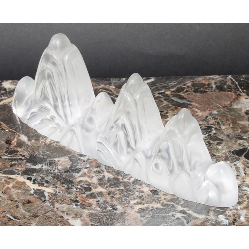 403 - A Chinese glass or rock crystal scholar's brush rest, as a rocky outcrop, 20cm wide