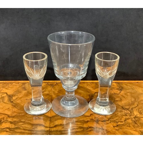 2142 - A pair of early 19th century firing glasses, slab-sided stems terminating in chequered panels, star ... 