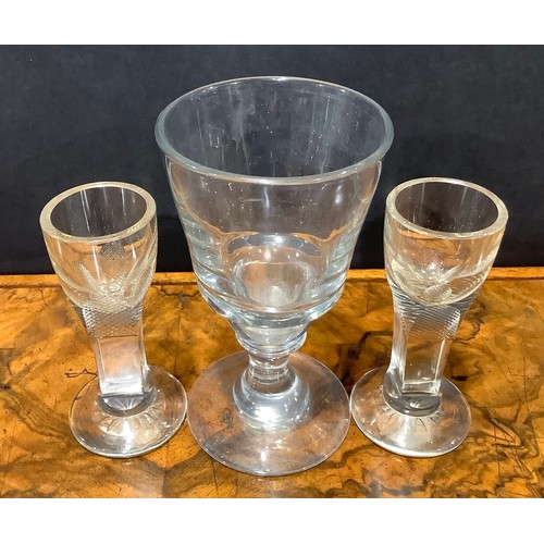 2142 - A pair of early 19th century firing glasses, slab-sided stems terminating in chequered panels, star ... 