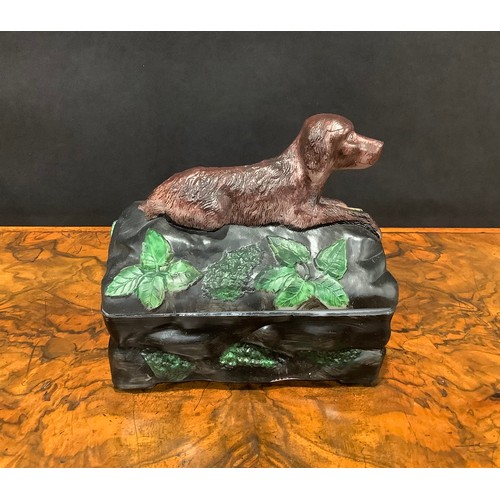 2188 - A Vallerysthal pressed glass novelty box and cover, surmounted by a hunting dog, game bag and gun, 1... 