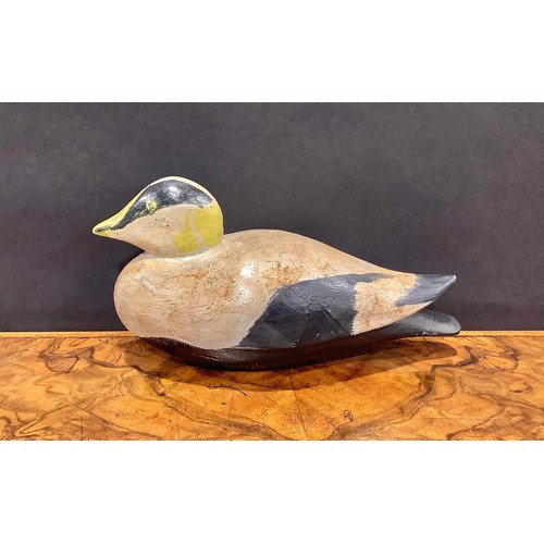 2079 - A painted softwood avian decoy, carved as a water fowl, 26cm long