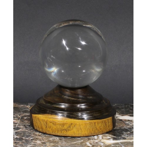 1867 - Mysticism and the Occult - a crystal ball, turned lignum vitae stand, 13cm high overall