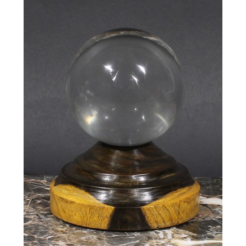 1867 - Mysticism and the Occult - a crystal ball, turned lignum vitae stand, 13cm high overall