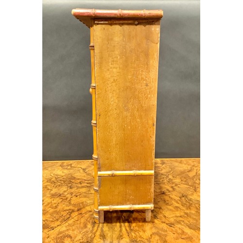 1861 - Miniature Furniture - an Aesthetic Movement faux bamboo miniature wardrobe, oversailing top above a ... 