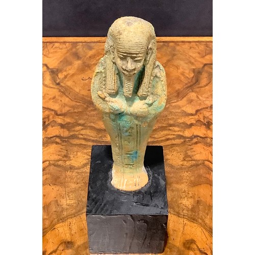 2573 - Antiquities - an Egyptian shabti, traces of turquoise glaze, 15cm high, collector's display plinth