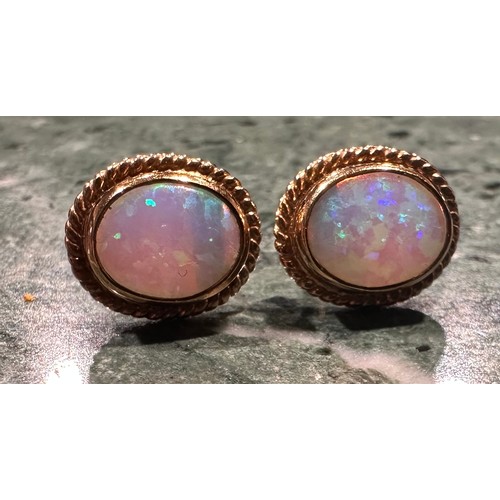 938 - An opal pendant and earring suite, articulated oval three stone linear pendant, with strong blue gre... 