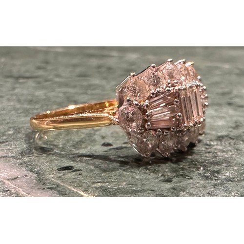 876 - A diamond cluster ring, shaped crest set with nine baguette and twelver round brilliant cut diamonds... 