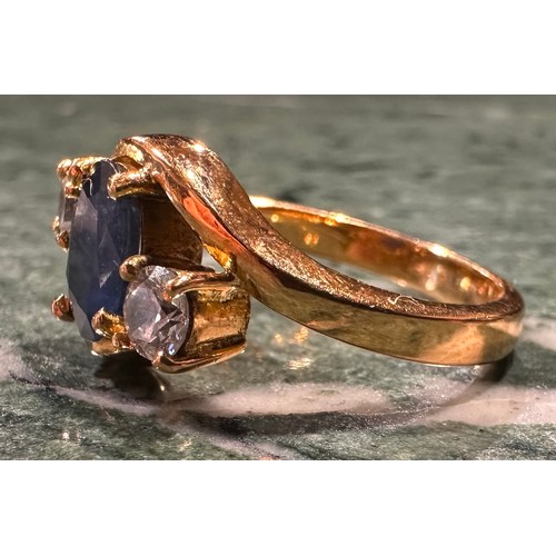 868 - A blue and white sapphire ring, twisted crest with central oval deep blue sapphire approx 1.50ct bet... 