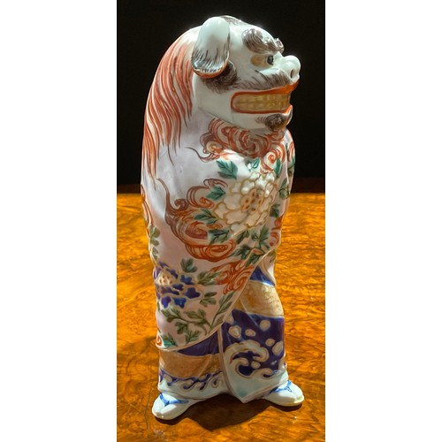 464 - A Japanese porcelain figure, as a pair of dancers in Chinese temple lion costume, the rear dancer pe... 