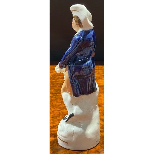 122 - An early 19th century Staffordshire pearlware figure group, The Vicar and Moses, with a sleeping vic... 