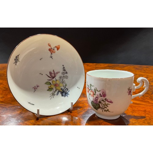 258 - A Meissen coffee cup and saucer, painted with floral bouquets and scattered flowers, brown line rims... 